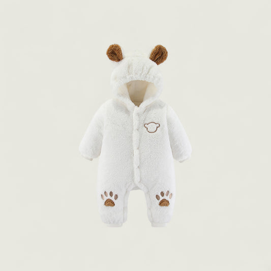 White baby snowsuit with brown accents on a light beige background