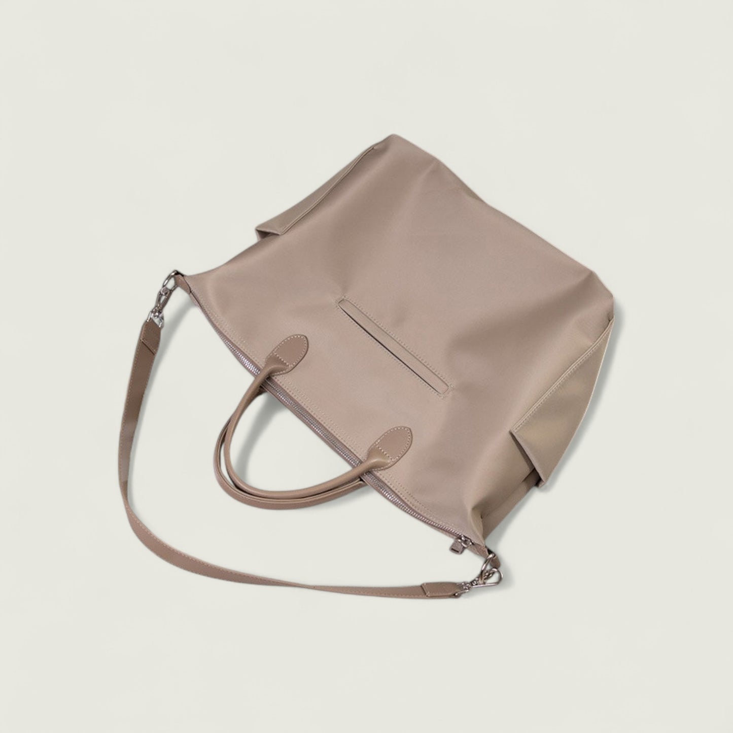 Beige handbag with a shoulder strap on a light beige background