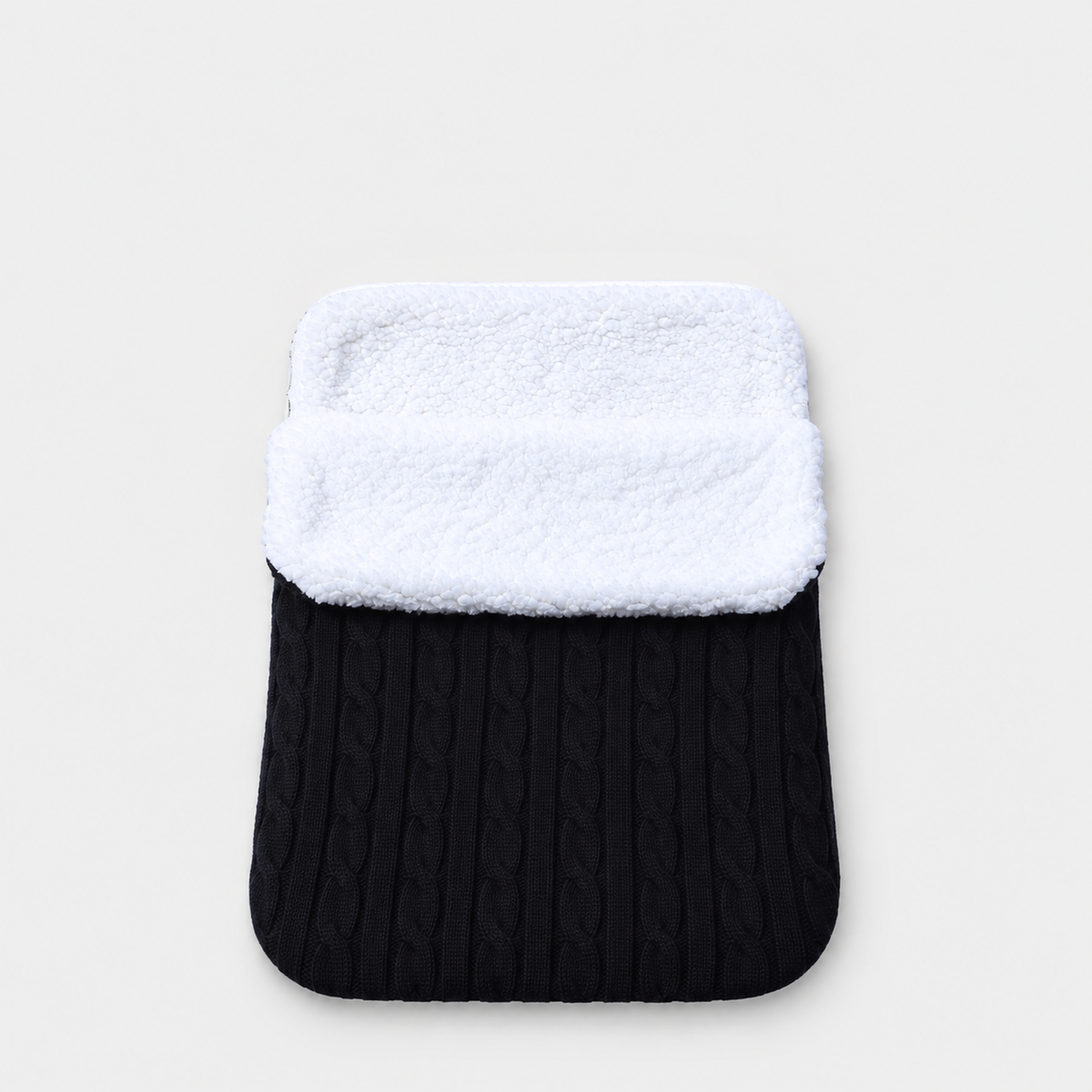 Black cable-knit envelope wrap with white plush lining
