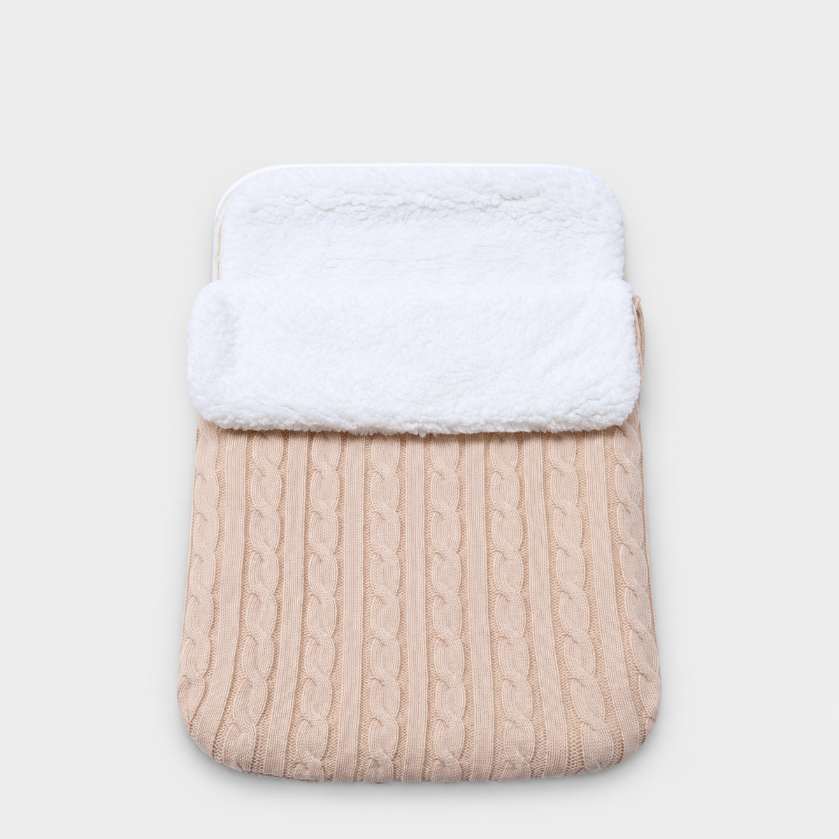 Beige cable-knit envelope wrap with white plush lining
