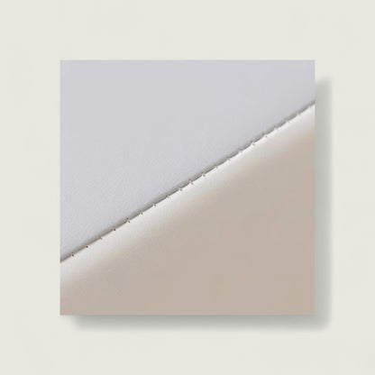 Two sheets of paper, one gray and one beige, on a light gray background.
