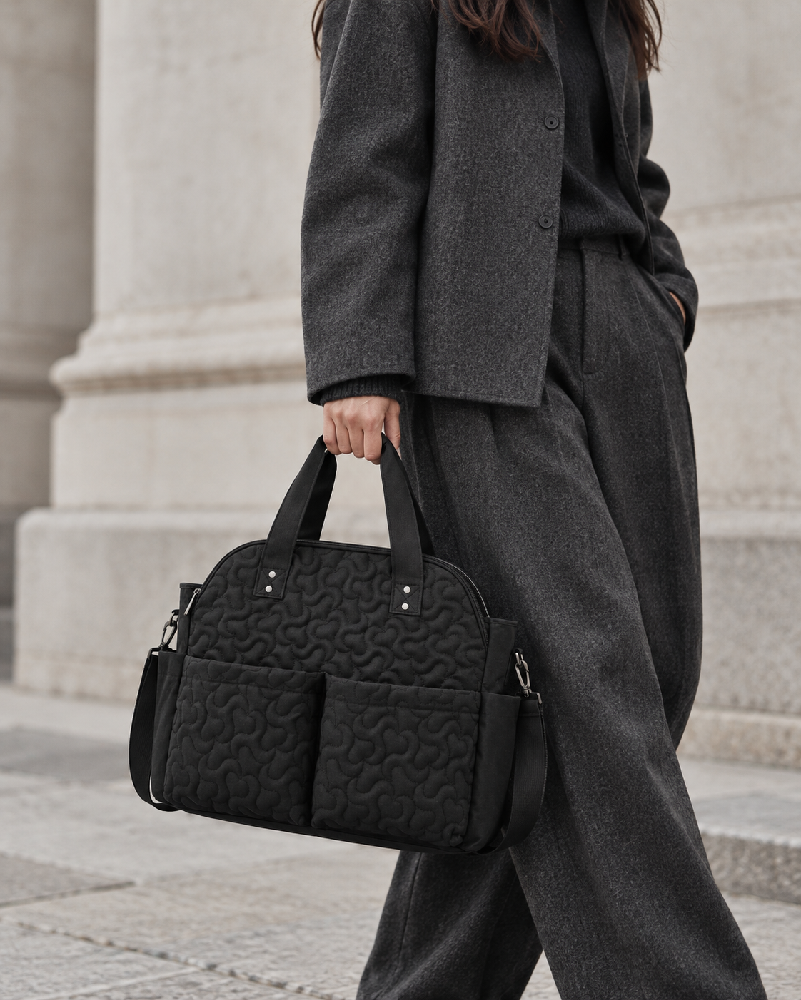 Black quilted bag styled with charcoal wool tailoring
