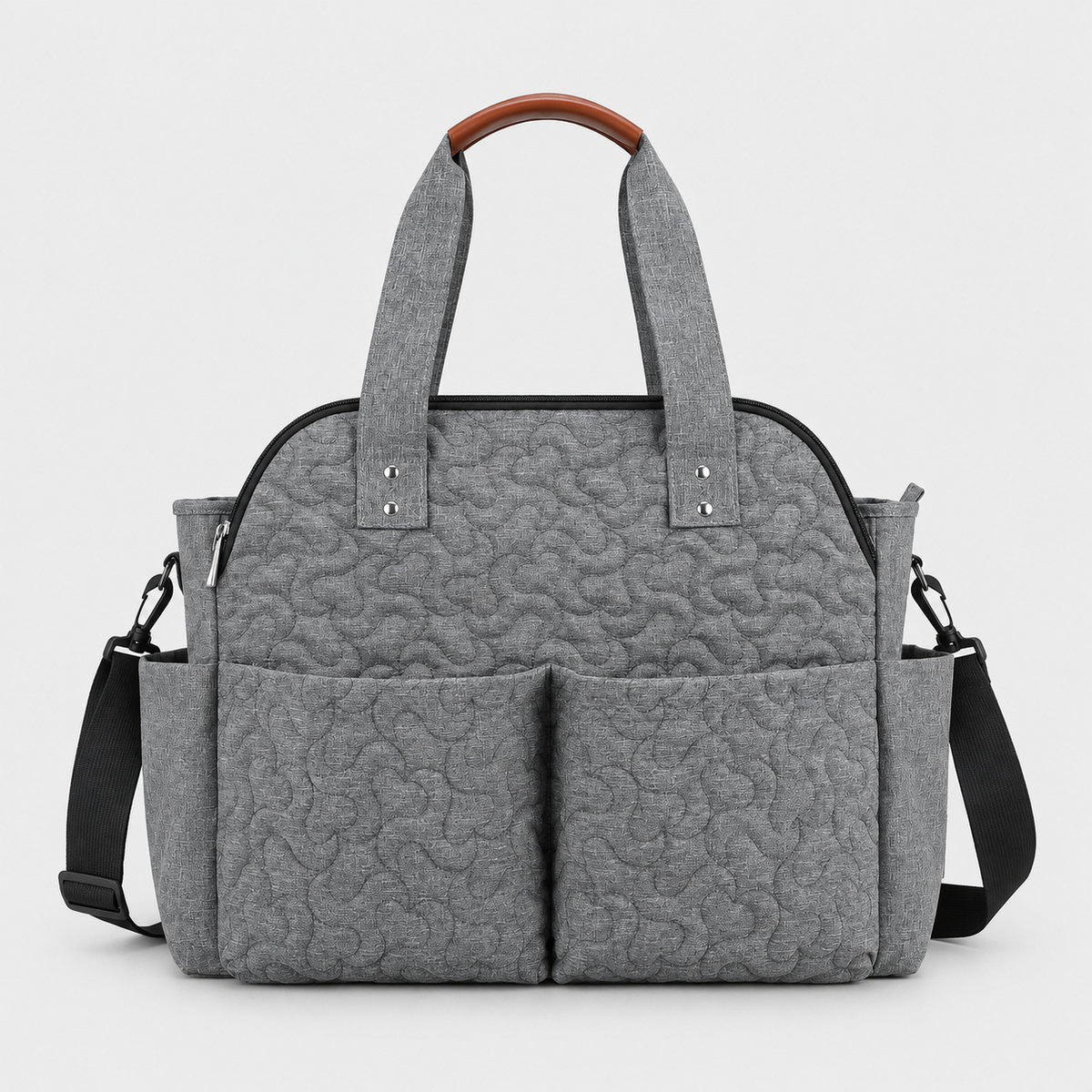 Grey quilted changing bag with brown handle grip
