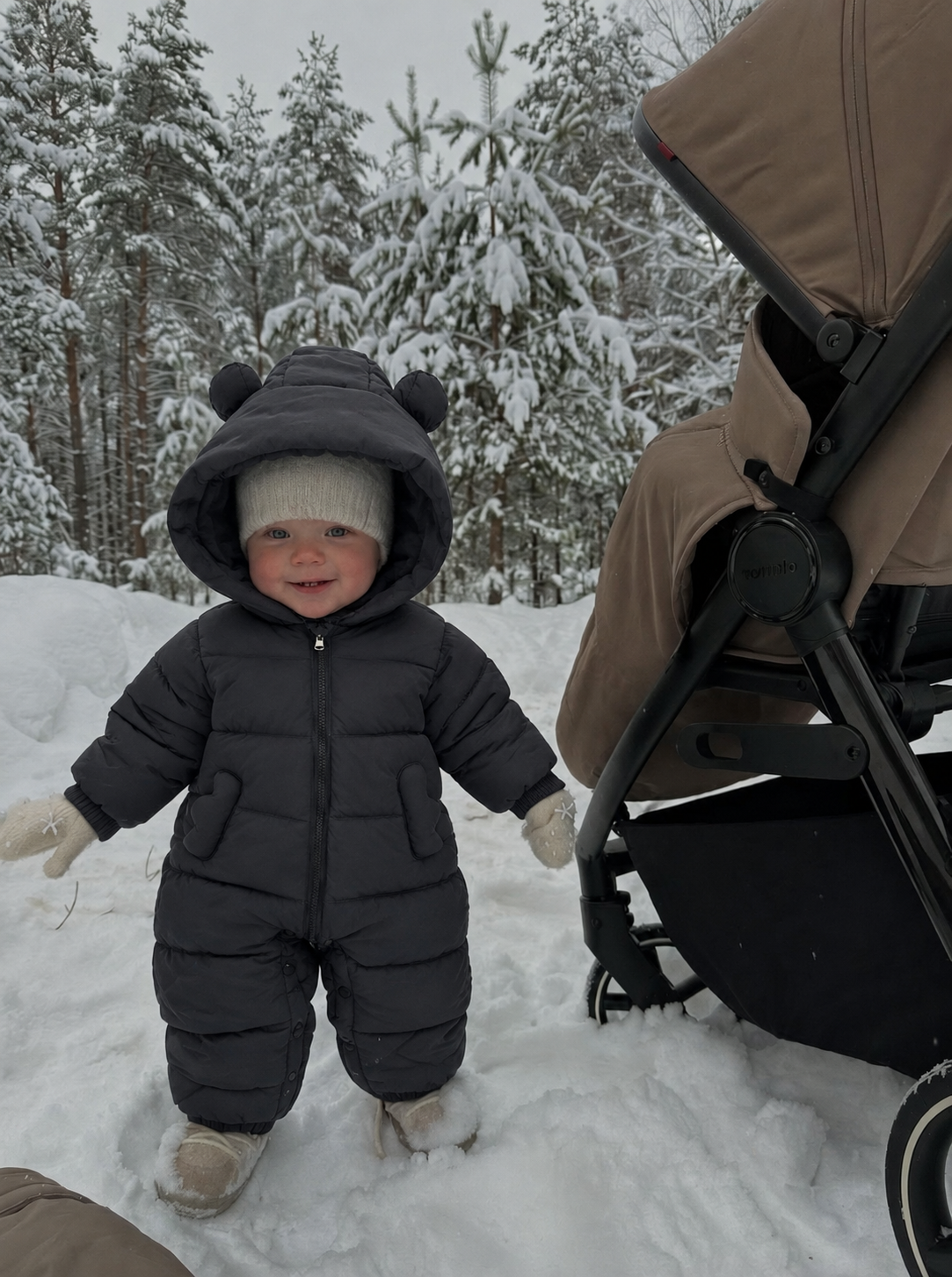 Charcoal bear-ear jumpsuit shown beside a stroller in a winter setting