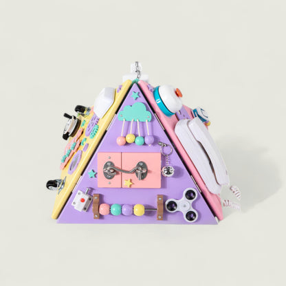 Triangular wall hanging with various toys and items on a light gray background