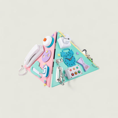 Colorful triangular wall organizer with various decorative items on a light gray background