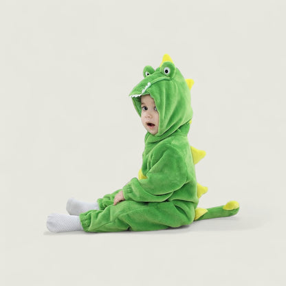 Child wearing a green dinosaur onesie on a light gray background