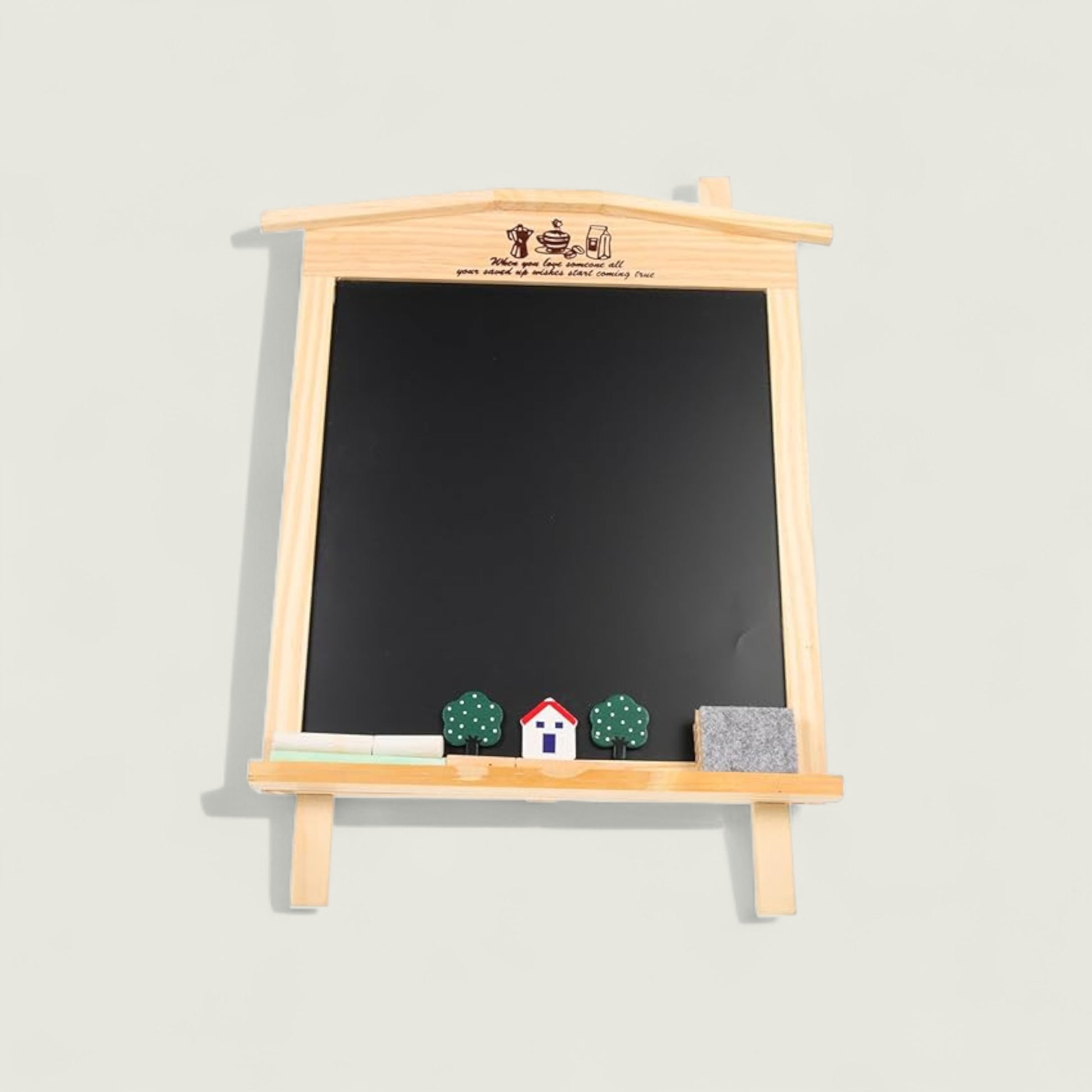 Blackboard with wooden frame and small decorative items on a light gray background