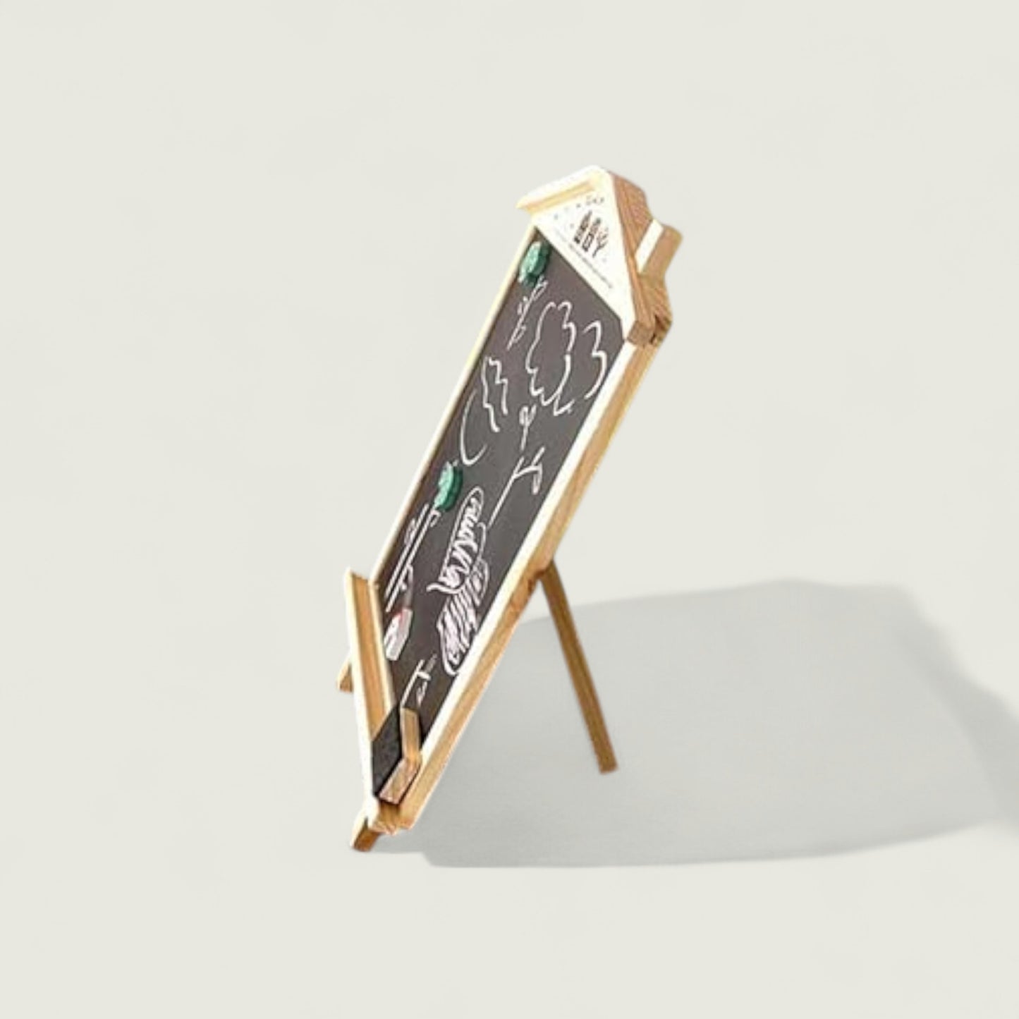 Small blackboard with wooden stand on a light gray background