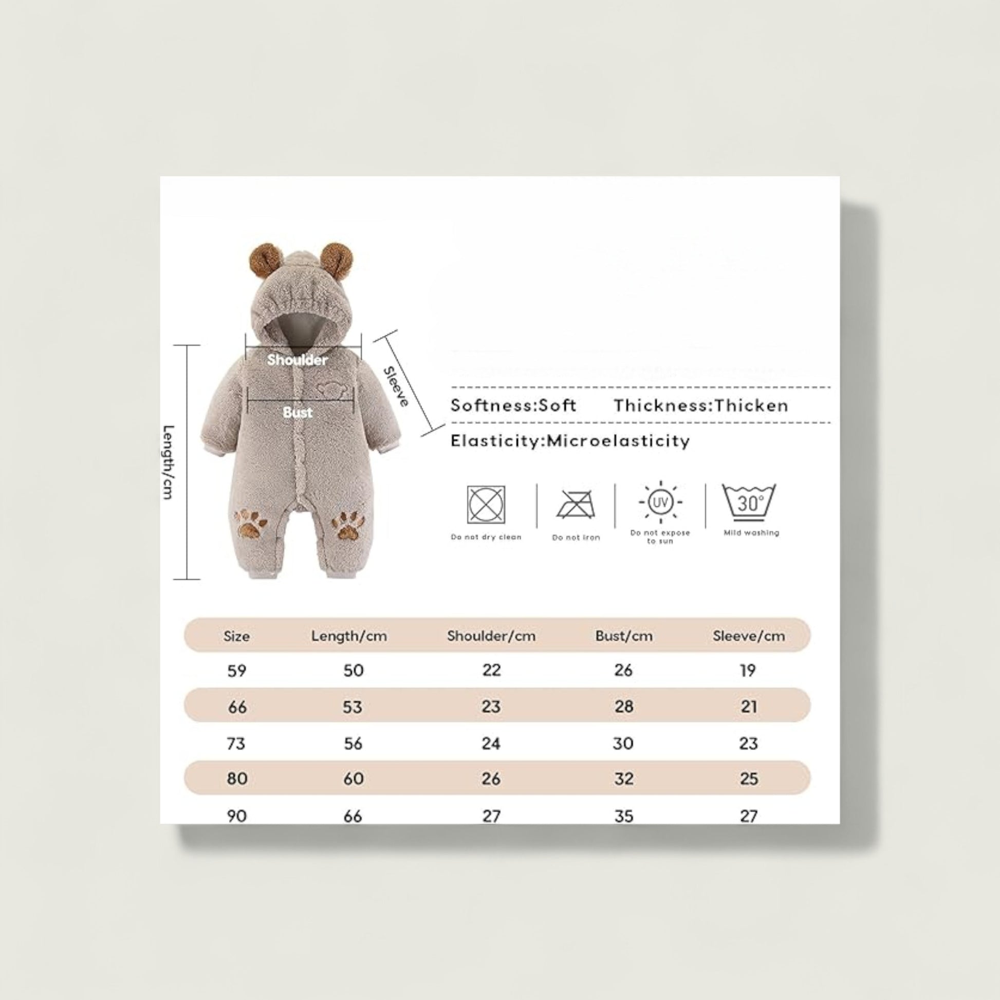 Baby romper with measurement chart on a light gray background