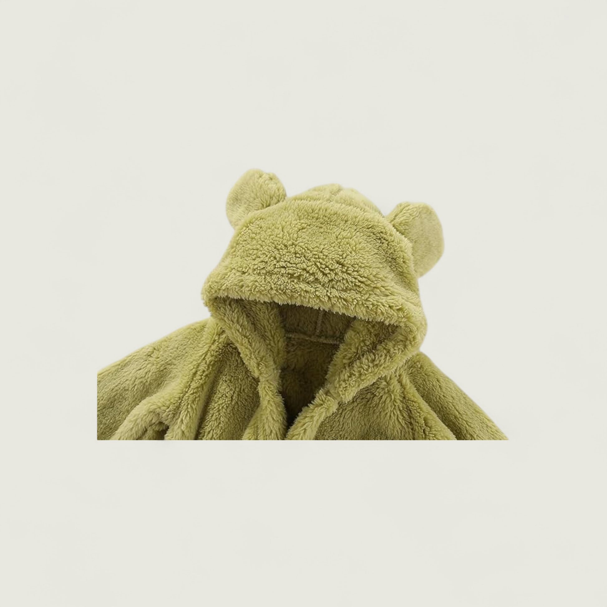 Green children's robe with bear ears on a light beige background