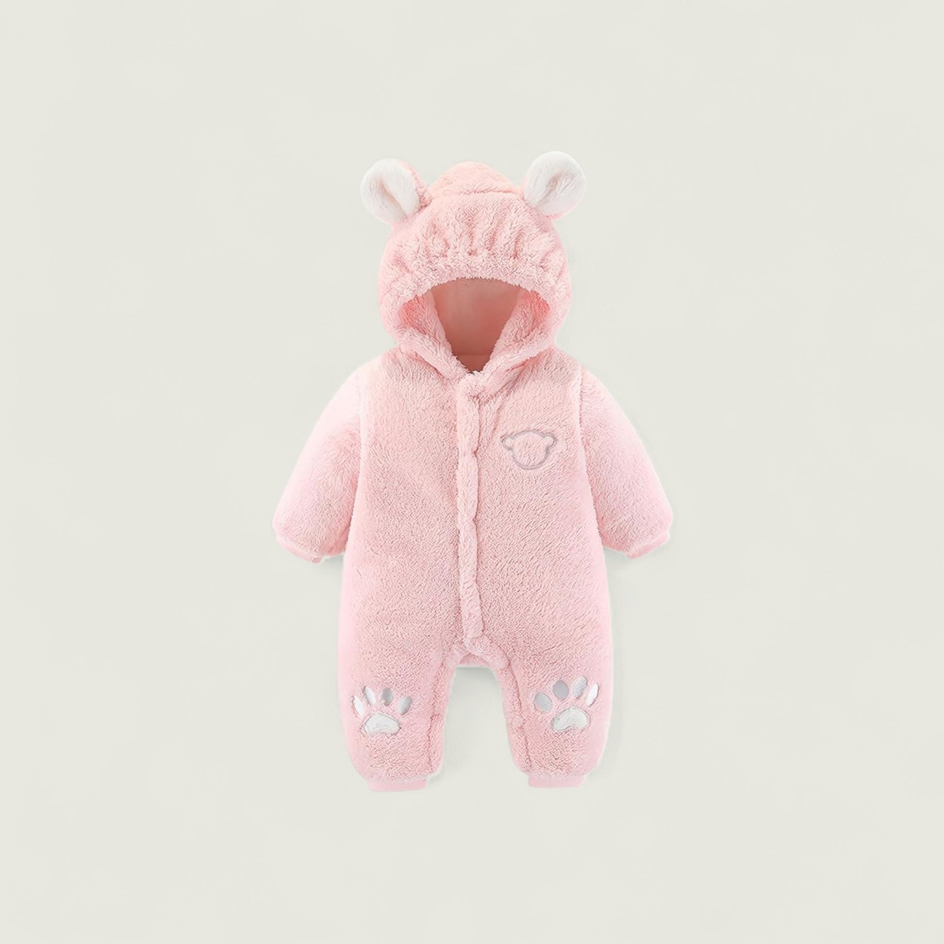 Pink baby snowsuit with hood and paw prints on a light gray background