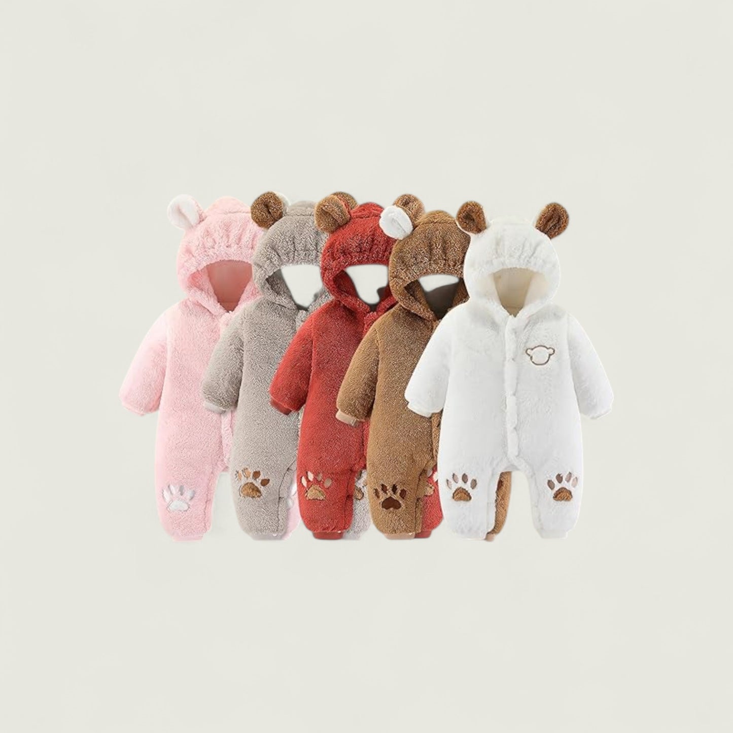 Five baby rompers with bear designs in pink, gray, red, brown, and white on a light beige background.