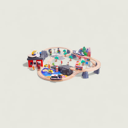 Toy train set with various figures and buildings on a light gray background