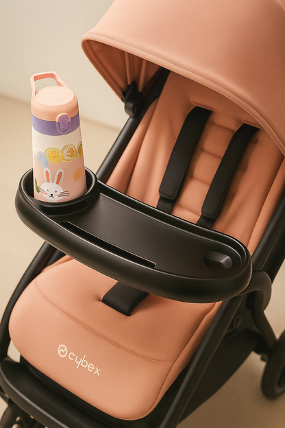 Pink baby stroller with a bottle holder and Cybex branding.