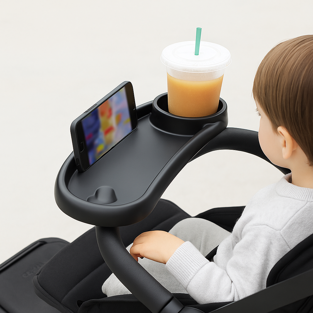Child in a stroller with a tray holding a phone and a drink.