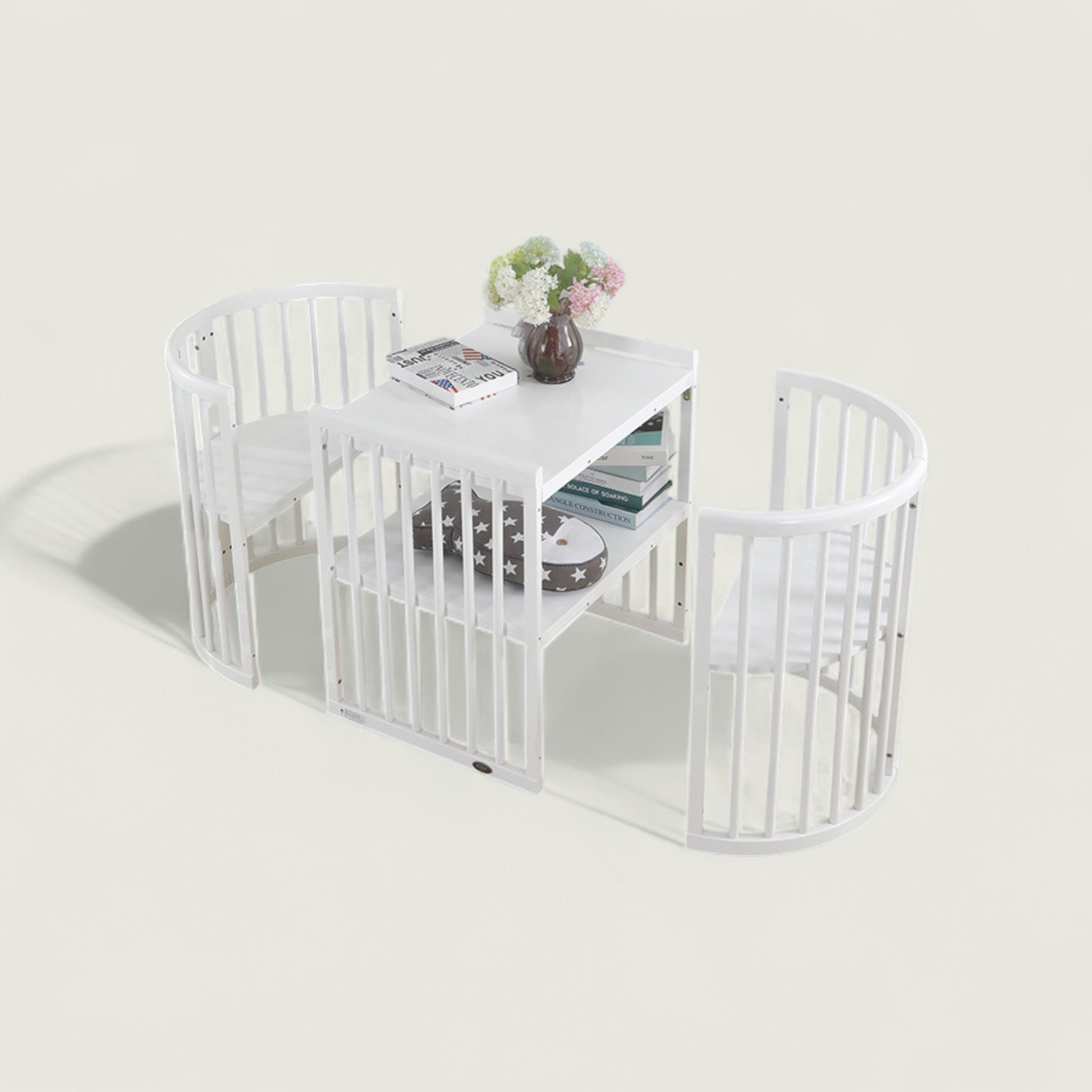 White pet playpen with a small table inside on a light gray background