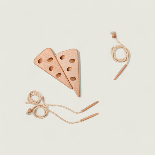 Wooden toy with two triangular pieces and strings on a light background