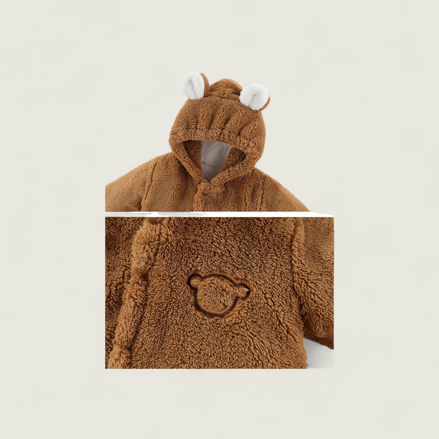 Brown teddy bear-themed children's hoodie with a close-up of the brand logo on a beige background.