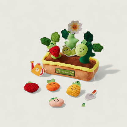 Toy fruit and vegetable set with a planting box on a light beige background