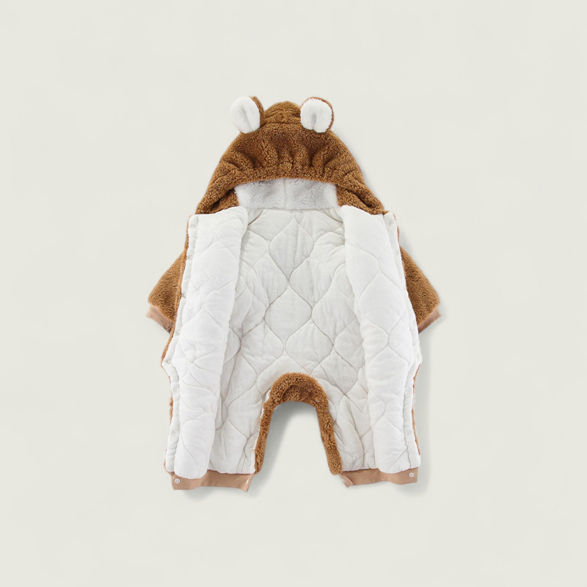 Children's animal-themed outfit with a hood on a beige background