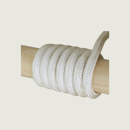 White rope coiled around a wooden post on a beige background