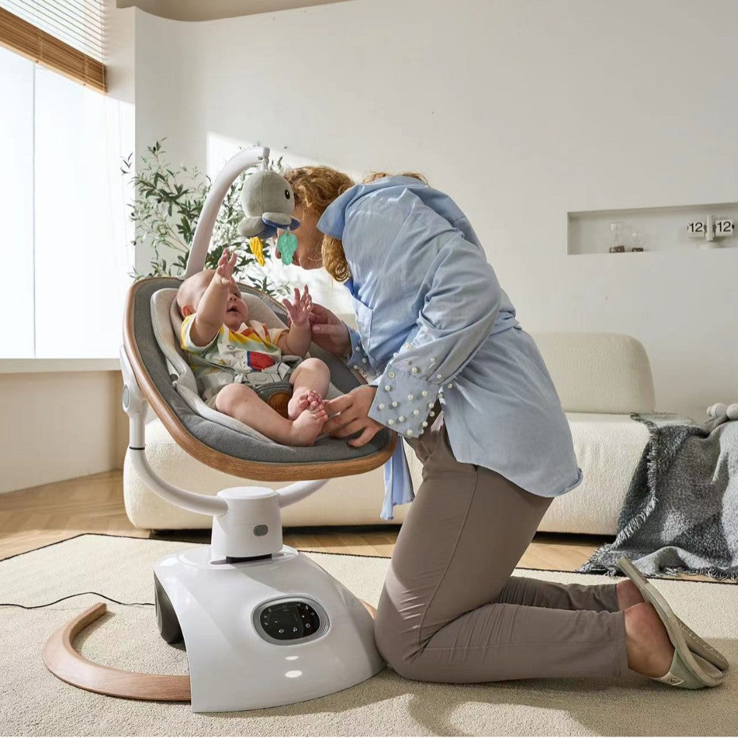 Woman interacting with a baby in a modern baby swing in a living room.
