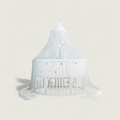 White crib with canopy on a light gray background