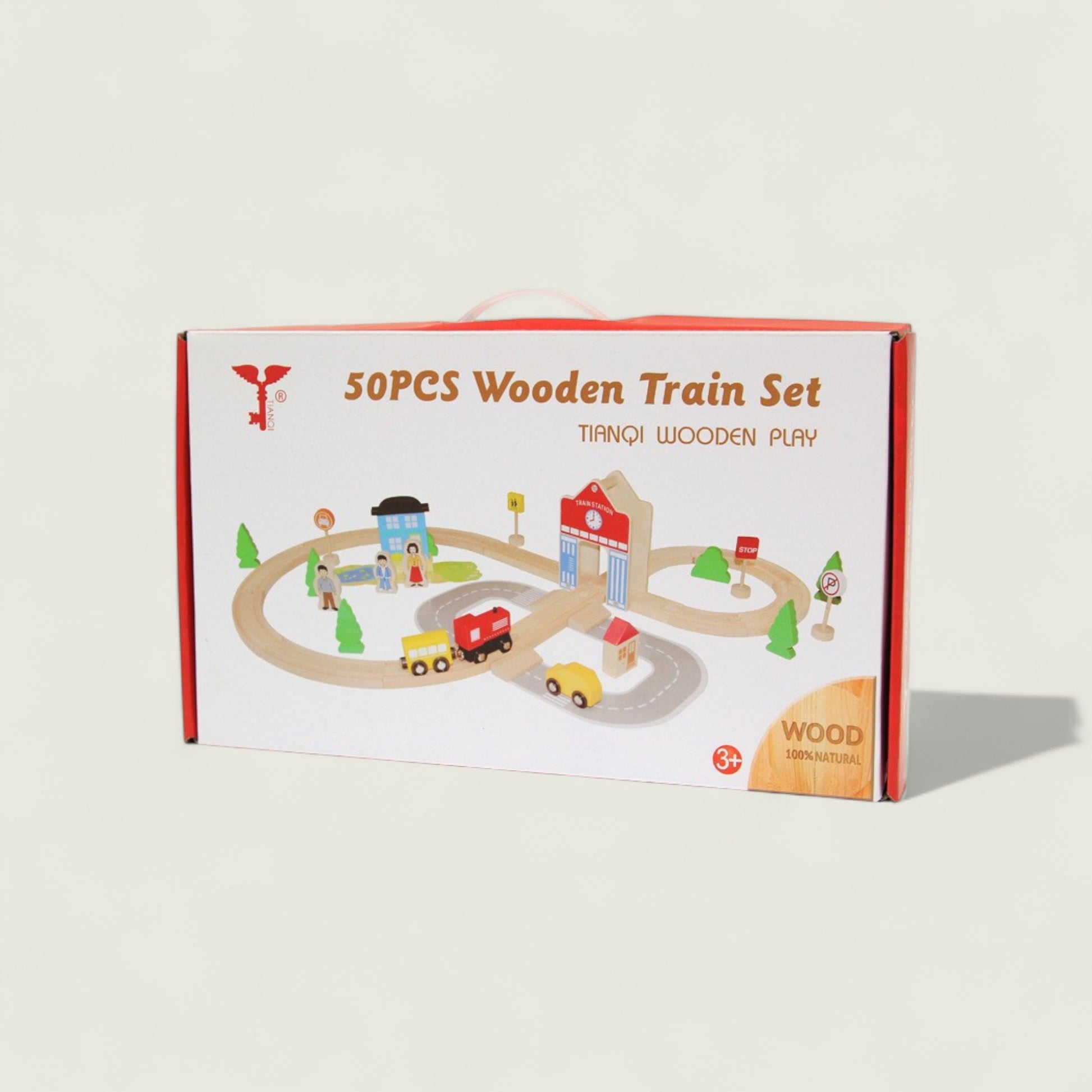 Box of 50pcs wooden train set with toy cars and buildings on a beige background