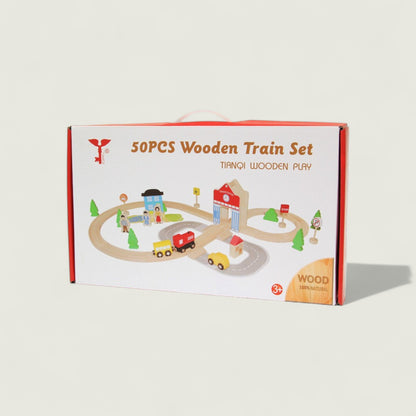 Box of 50pcs wooden train set with toy cars and buildings on a beige background