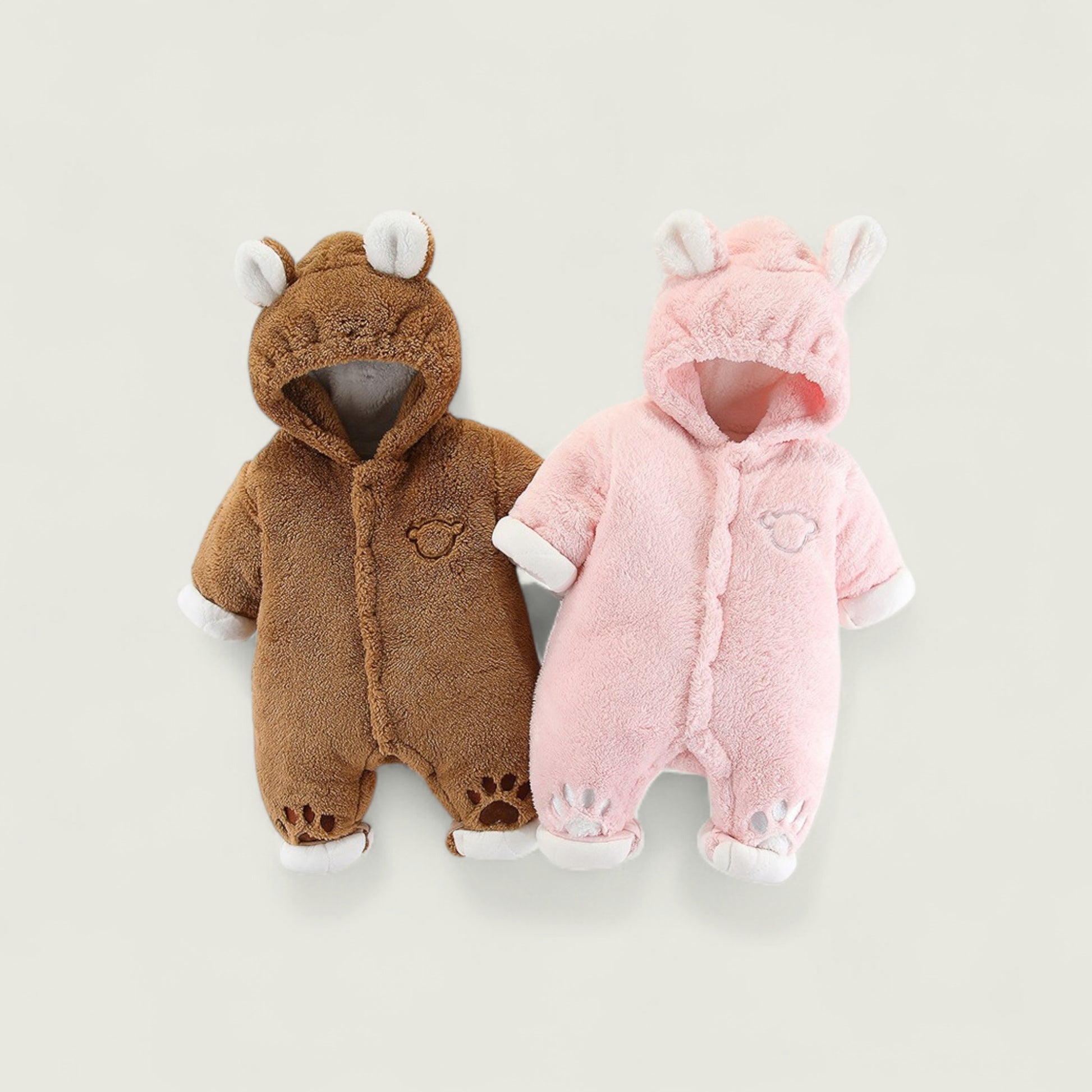Two baby onesies, one brown and one pink, on a light gray background.