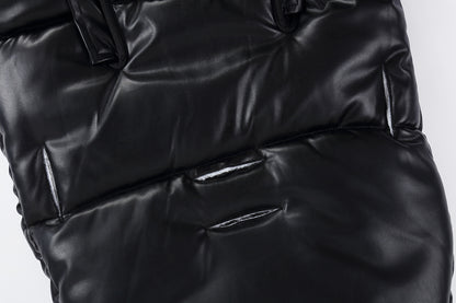 Close-up of a black puffer jacket on a white background