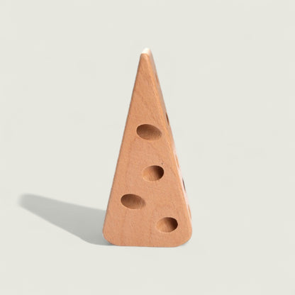 Wooden cheese wedge with holes on a light gray background