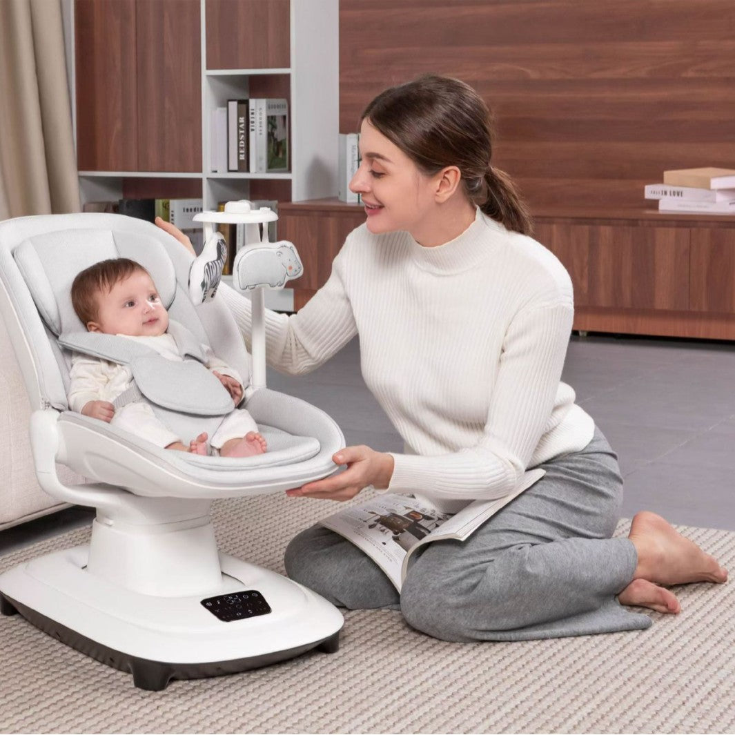 Woman interacting with a baby in a white baby seat in a home setting.