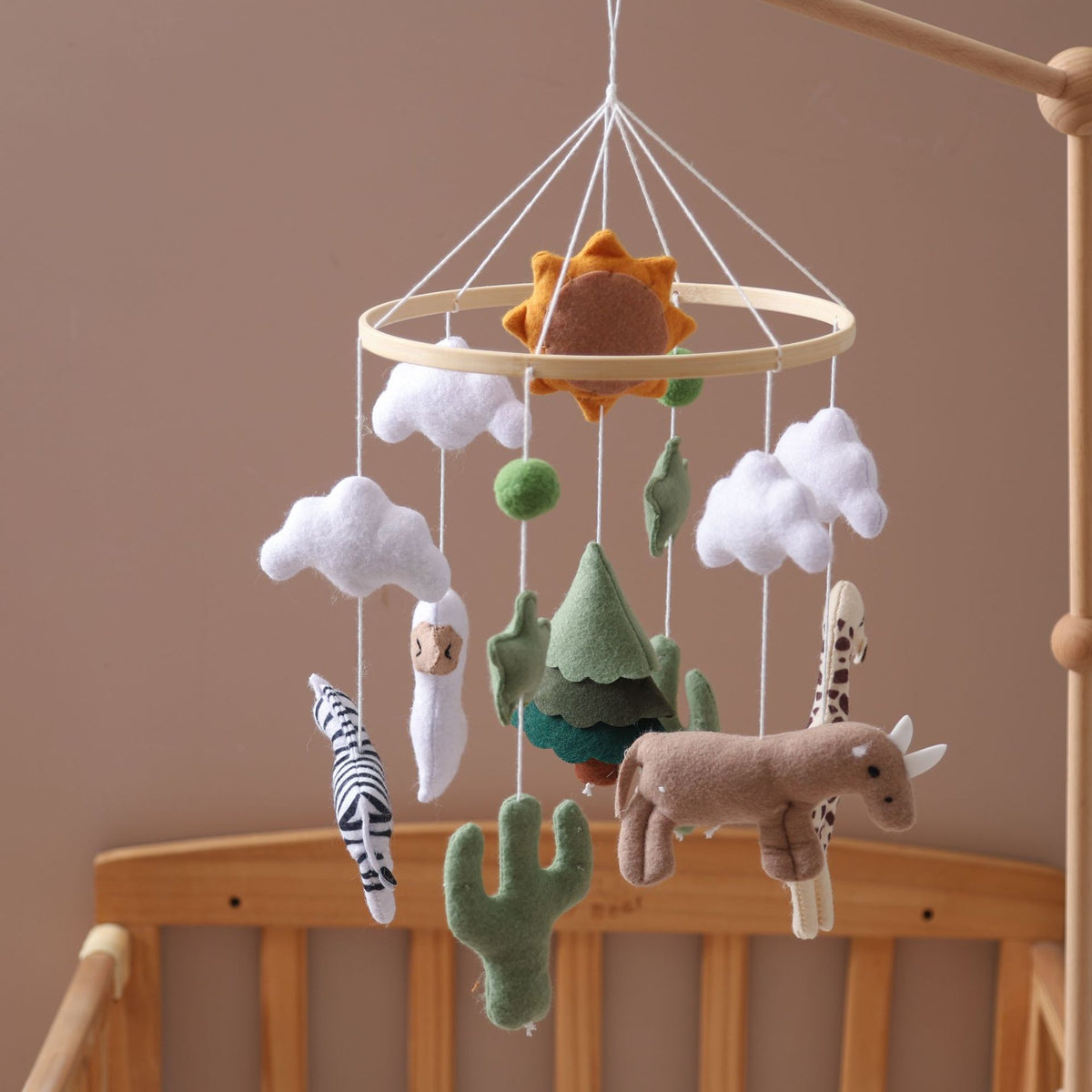 Sun Forest felt crib mobile above a crib