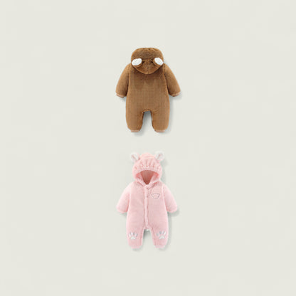 Brown and pink baby onesies on a light beige background