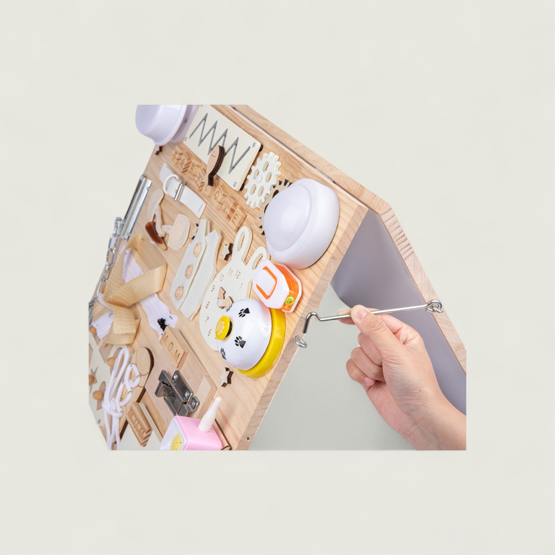 Wooden tool set with various tools and a small white ball on a light gray background