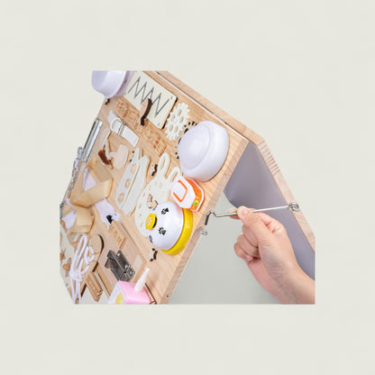 Wooden tool set with various tools and a small white ball on a light gray background