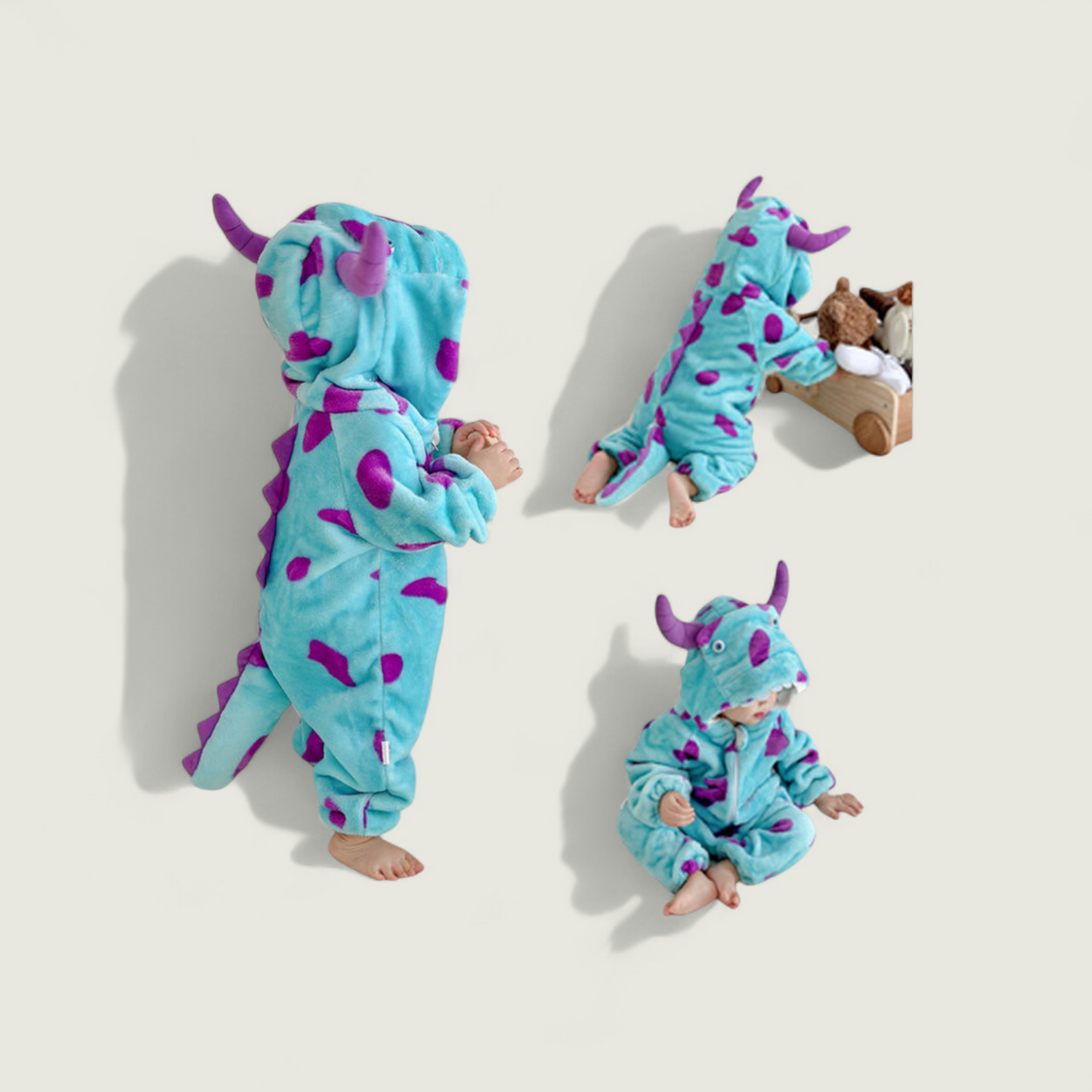 Children wearing blue dragon-themed onesies on a light background