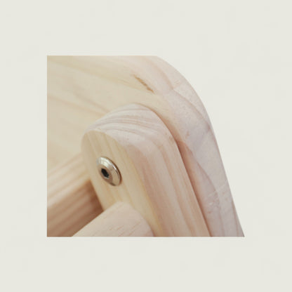 Close-up of a wooden product with a metal screw on a light beige background