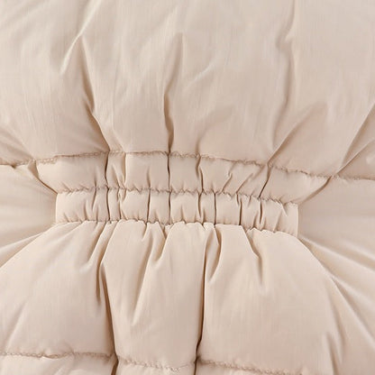 Close-up of beige quilted jacket with a focus on the waistband and stitching.