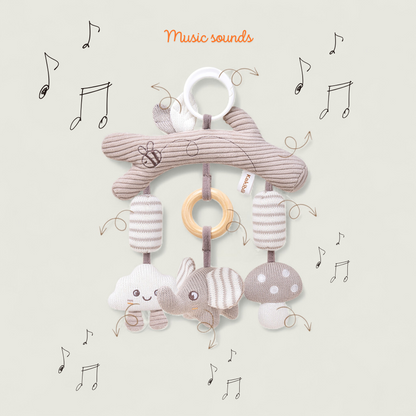 Baby mobile with soft toys and rings on a light background with musical notes.