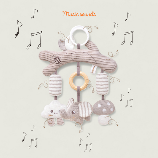 Baby mobile with soft toys and rings on a light background with musical notes.
