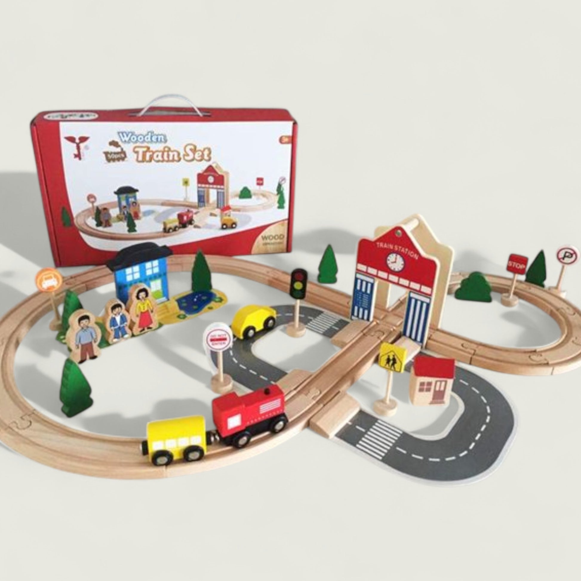 Wooden train set with tracks, cars, and buildings on a white background