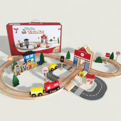 Wooden train set with tracks, cars, and buildings on a white background