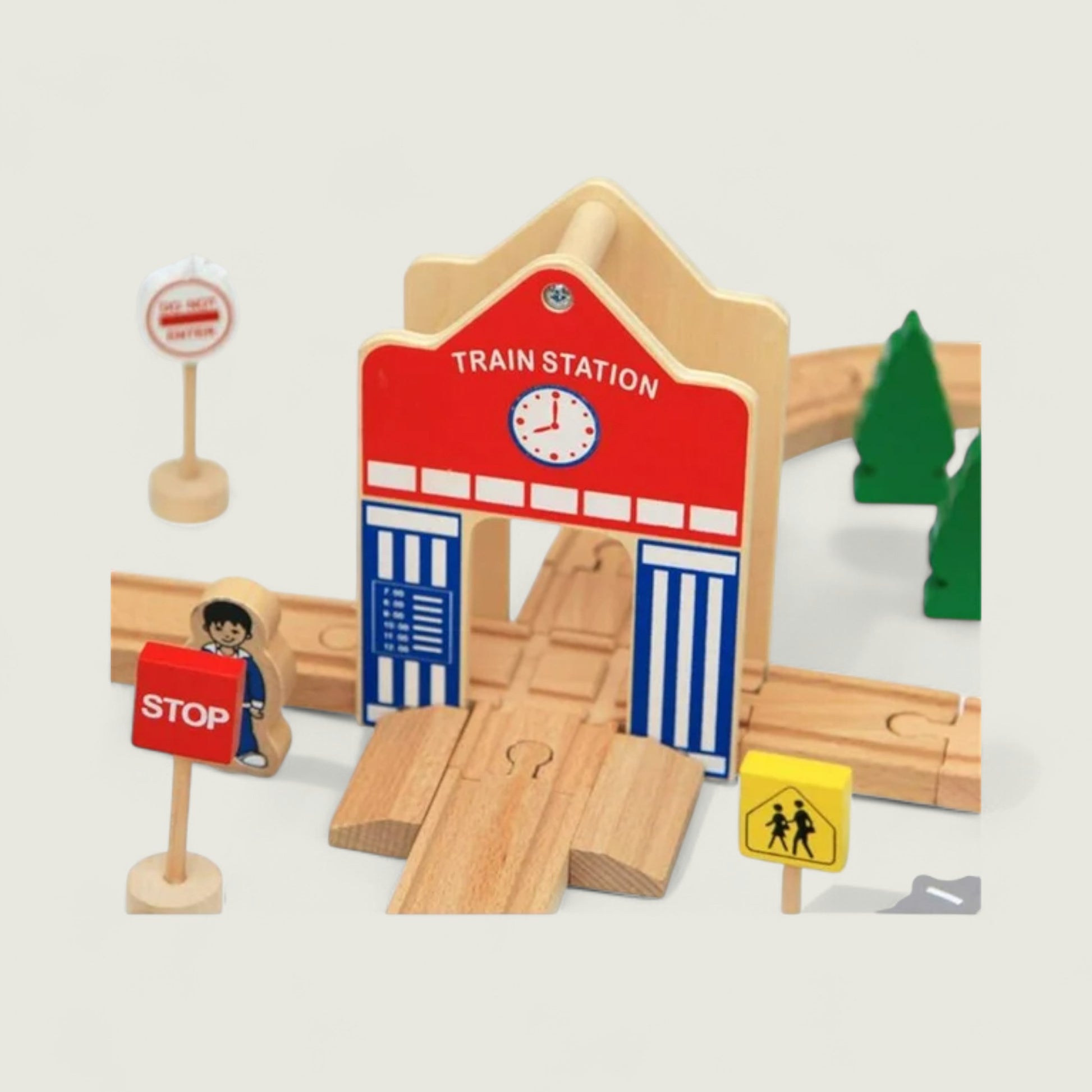 Wooden toy train station set with tracks and signs on a light gray background