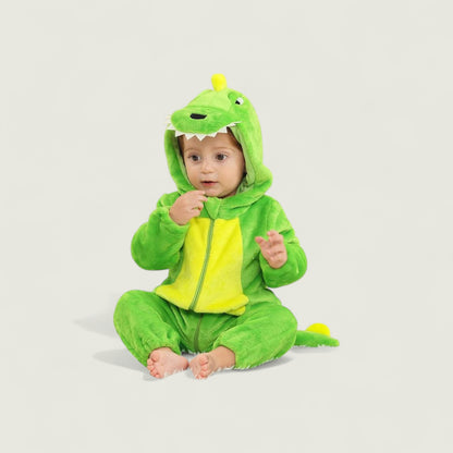 Baby in a green dinosaur costume on a light gray background