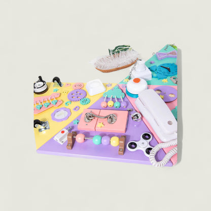 Colorful children's activity board with various educational tools on a light gray background