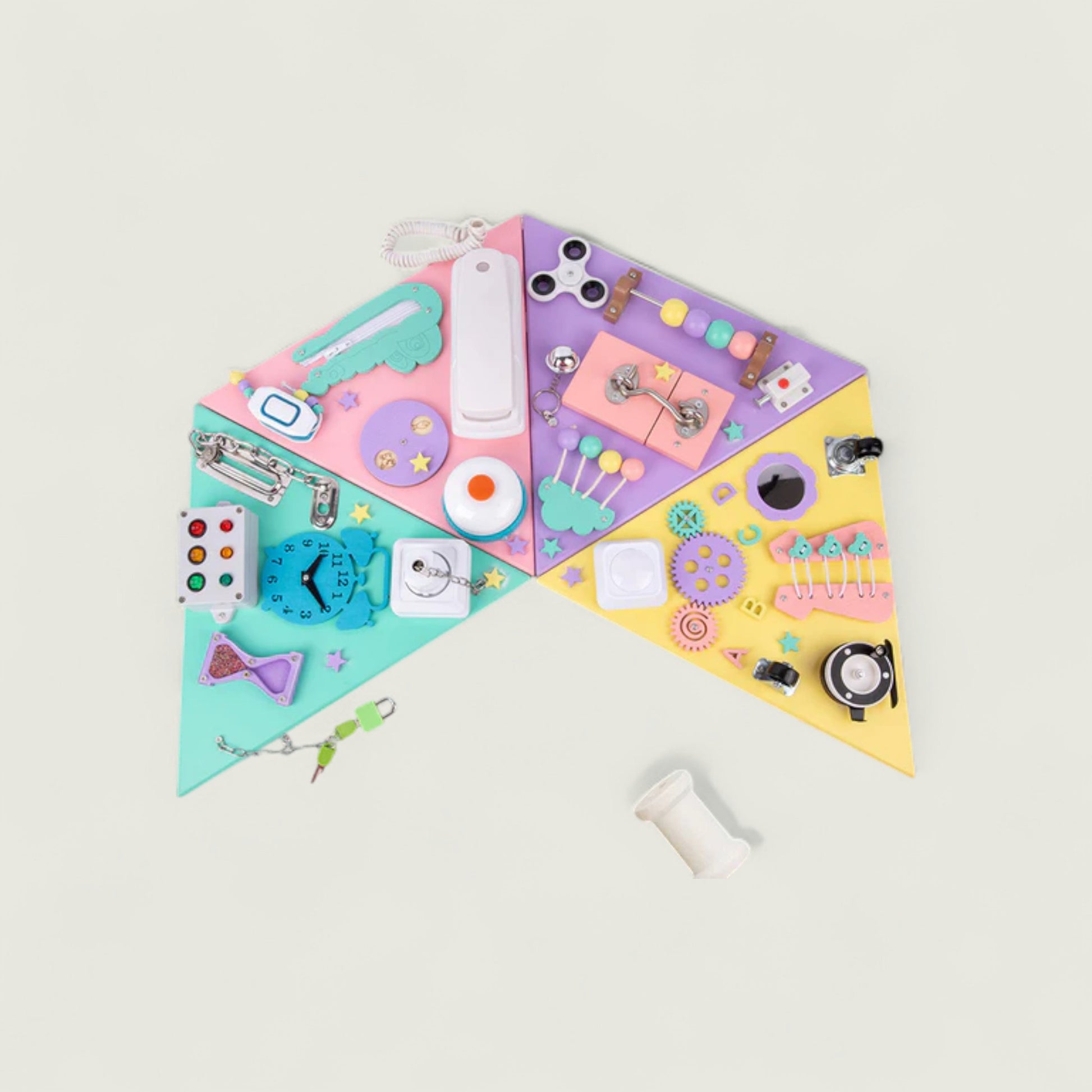 Colorful triangular board with various small objects on a light gray background