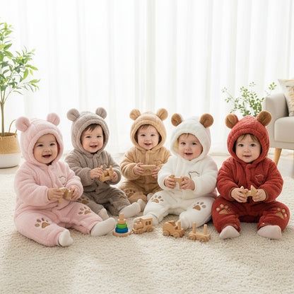 Five children in bear-themed outfits sitting on a carpeted floor.